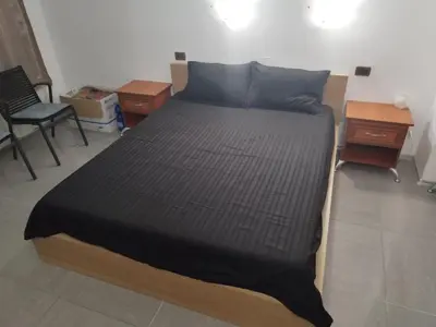 a bed in a room with two chairs and a table at California complex in Sunny Beach