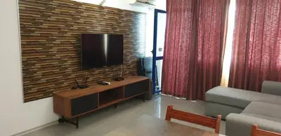 a living room with a television on a brick wall at California complex in Sunny Beach