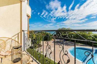 a balcony with a view of a swimming pool at Royal Bay Apartaments - Sveti Vlas in Sveti Vlas