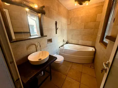 a bathroom with a sink and a tub and a toilet at Arthotel Oscar I Sozopol in Sozopol