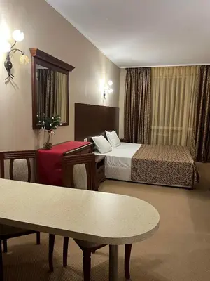 a hotel room with a bed and a table at Private room Festa Pomorie in Pomorie