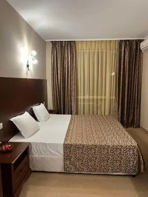 a hotel room with a bed and a window at Private room Festa Pomorie in Pomorie