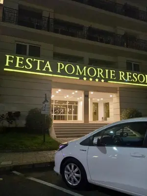 a white car parked in front of a restaurant at Private room Festa Pomorie in Pomorie
