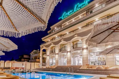 a hotel with a swimming pool in front of a building at Casa Deniso - The Home of Chill in Byala