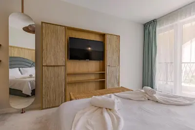 a bedroom with a bed and a tv in a room at Casa Deniso - The Home of Chill in Byala