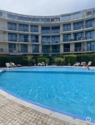 a large swimming pool in front of a building at Голямо и просторно студио Слънчев бряг in Sunny Beach