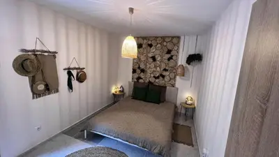 a bedroom with a bed with a pile of logs at Apartment Blue Summer II in Varna City