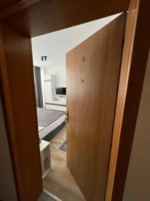 an open door to a bedroom with a bed at Manolovi Guest House in Obzor