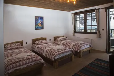 a room with three beds and a window at Chateau Erkech Triple Room in Kozichino
