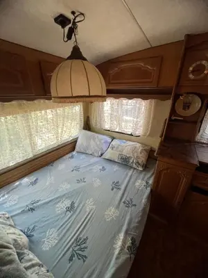 a bed in the back of a camper van at Каравана градина in Sozopol