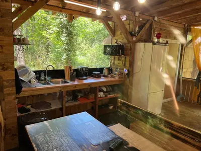a kitchen with a refrigerator and a sink in a cabin at Каравана градина in Sozopol