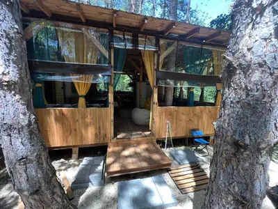 a tree house in the middle of two trees at Каравана градина in Sozopol