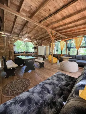 a living room with couches and a pool table at Каравана градина in Sozopol
