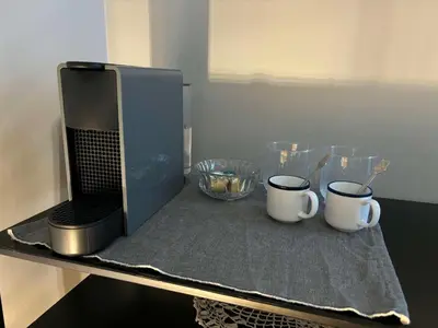 a table with two coffee mugs and a microwave at Casa Mint in Sozopol