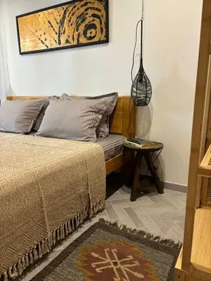 a bedroom with a bed and a side table at Casa Mint in Sozopol
