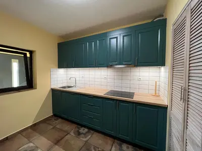 a kitchen with green cabinets and a sink at Villa Alessandra in Emona