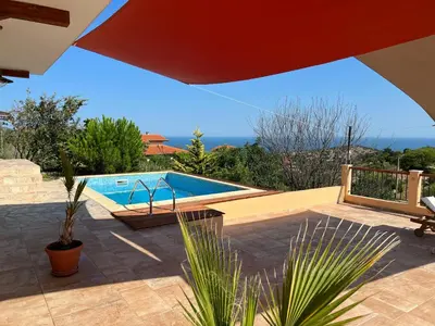 a swimming pool sitting next to a house at Villa Alessandra in Emona