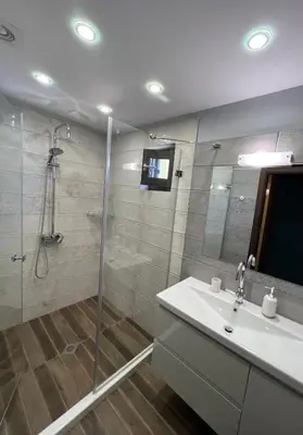 a bathroom with a shower and a sink and a mirror at Villa Alessandra in Emona