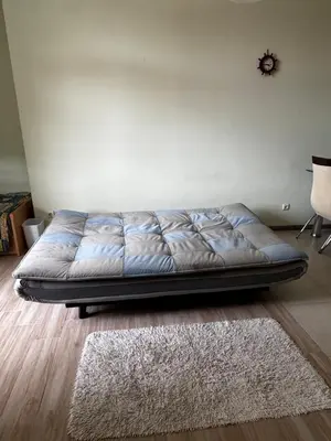 a bed sitting in a room with a rug at 'Oasis' Ravda Apartment, Nessebar in Ravda
