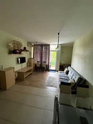 a living room with a couch and a television at 'Oasis' Ravda Apartment, Nessebar in Ravda