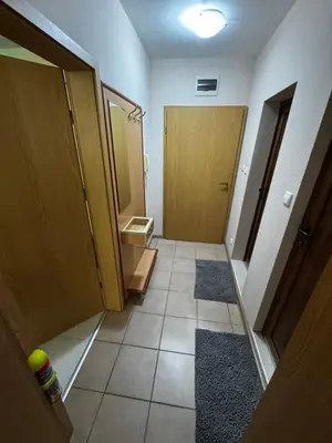 a bathroom with two wooden doors and a tile floor at 'Oasis' Ravda Apartment, Nessebar in Ravda