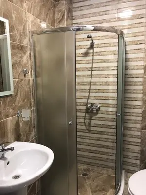 a bathroom with a shower and a sink at Marina Bay Apartmant in Pomorie