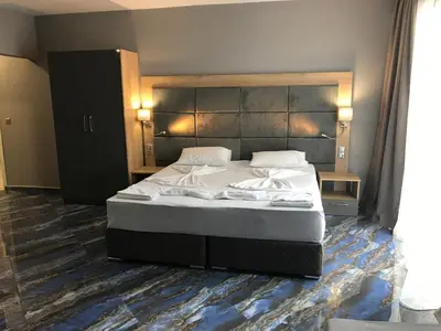 a bedroom with a large bed in a room at Marina Bay Apartmant in Pomorie