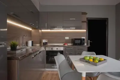 a kitchen with a table with a bowl of fruit on it at Marina Bay Apartmant in Pomorie