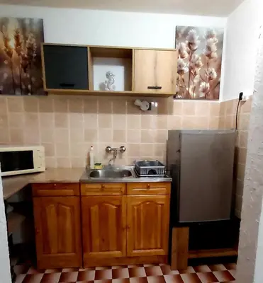 a small kitchen with a sink and a refrigerator at Stela in Burgas City