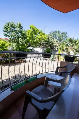 two chairs on a balcony with a view of a road at AR Luxury Apartments Ravda in Ravda