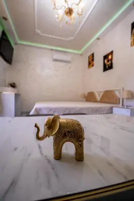 a small elephant toy sitting on a table in a bedroom at AR Luxury Apartments Ravda in Ravda