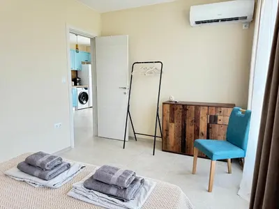 a bedroom with a bed and a mirror and a chair at Boho and More in Sozopol