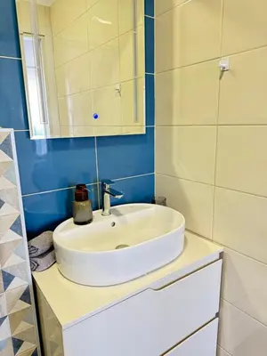 a bathroom with a white sink and a mirror at Boho and More in Sozopol