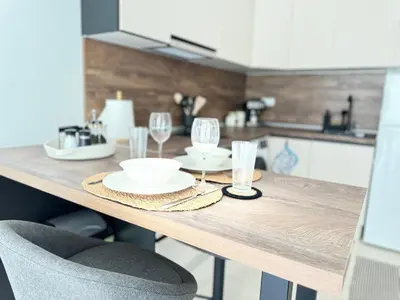 a wooden table with plates and glasses on it at Deco Fusion in Sozopol