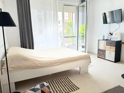 a bedroom with a bed and a large window at Deco Fusion in Sozopol
