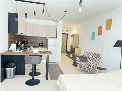 a kitchen and living room with a table and chairs at Deco Fusion in Sozopol