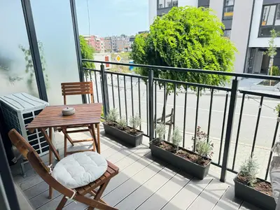 a balcony with a table and chairs and plants at Deco Fusion in Sozopol