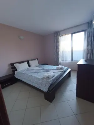 a bedroom with a bed and a window with towels on it at Oasis beach house , apartment Nevena in Lozenets