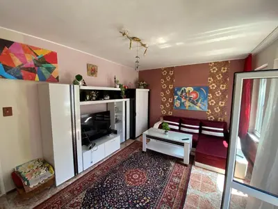 a living room with a couch and a television at Centrum in Burgas City
