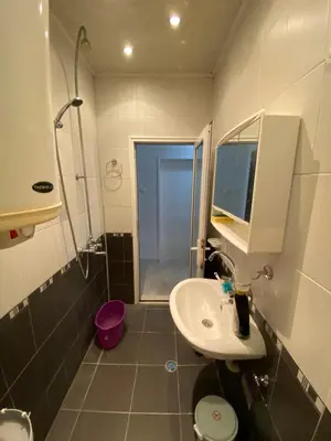a bathroom with a sink and a shower and a toilet at Centrum in Burgas City