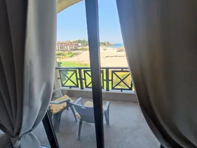 a room with a balcony with a view of the beach at Oasis Beach 2 bedroom apartment in Lozenets