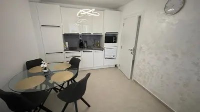 a dining room with a table and chairs in a kitchen at Polar Star 106 B in Saint Vlas in Sveti Vlas