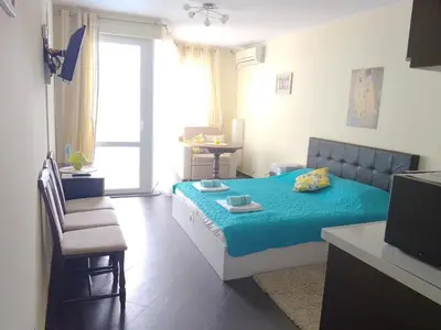 a bedroom with a bed with a blue blanket at Studio 41 in Ravda