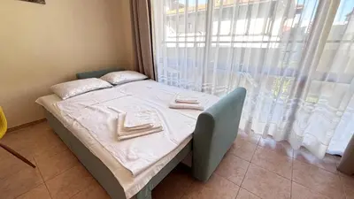 a small bed in a room with a window at One bedroom Apartment in Sunny Beach