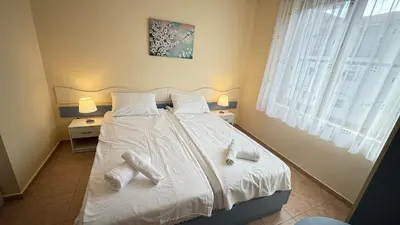 a bedroom with a bed with white socks on it at One bedroom Apartment in Sunny Beach