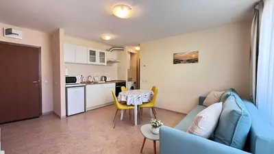 a living room with a blue couch and a table at One bedroom Apartment in Sunny Beach