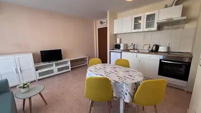 a kitchen with a table and chairs in a room at One bedroom Apartment in Sunny Beach