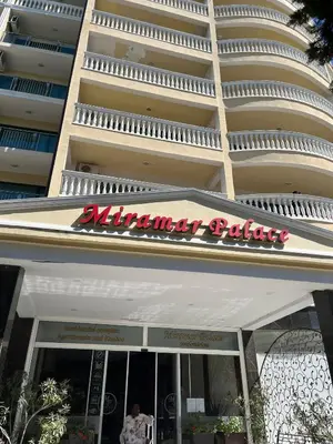 a sign for an entrance to an apartment building at Umi Apartments in Sunny Beach