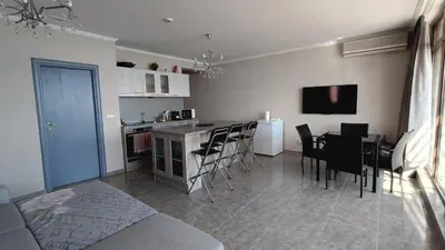 a living room with a kitchen and a table and chairs at Dolce Vita 1 Infinity Love in Sveti Vlas