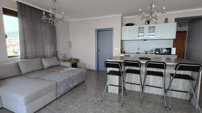 a living room with a couch and a table with bar stools at Dolce Vita 1 Infinity Love in Sveti Vlas